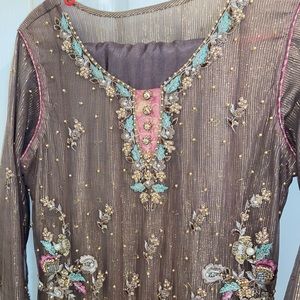 Purple metallic suit. Dupatta full of work. Straight trousers. Worn only once.